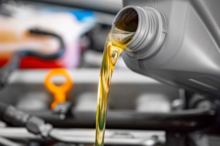 car oil being poured into the car.