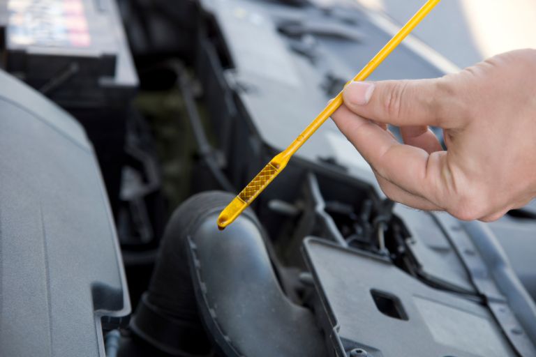 Someone checking their dipstick oil levels