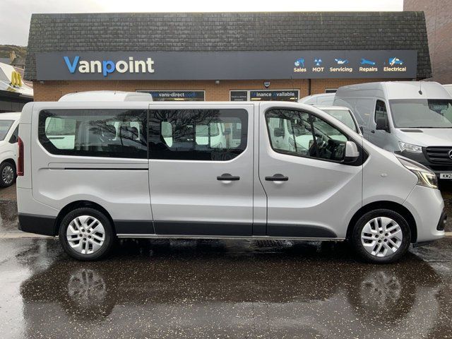 The side view of a grey minibus