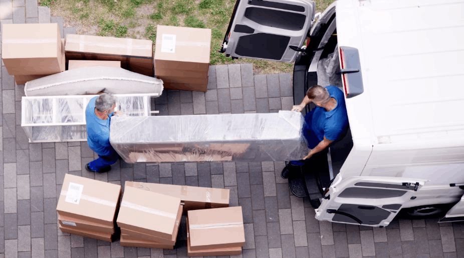 A Large Parcel Carried out of a Van by 2 Men
