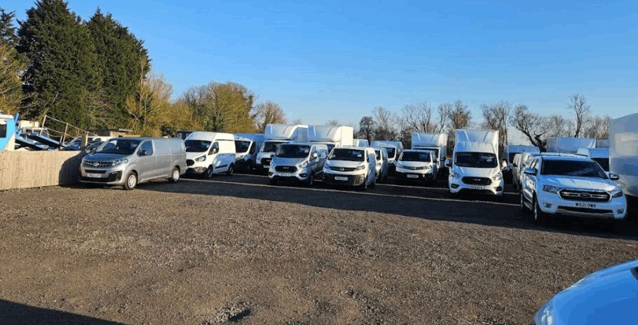Vans Lined Up on a Forecourt