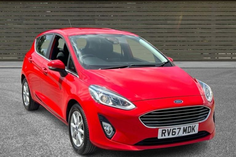 Red Ford Fiesta outside a car dealership