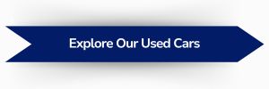 Blue banner button with text reading “Explore Our Used Cars”.