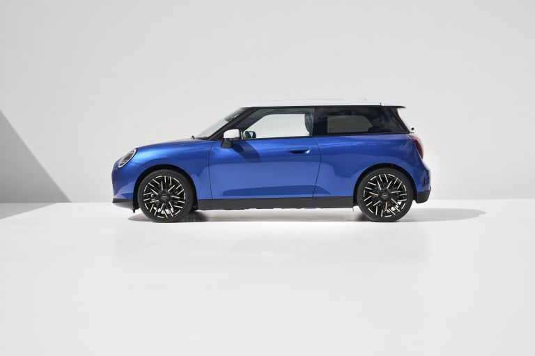 Blue MINI Cooper hatchback on a white studio background.