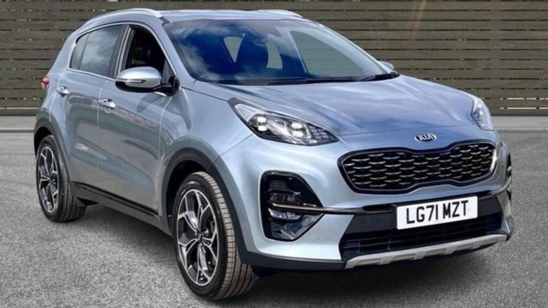 Silver Kia Sportage SUV front-side view with LED headlights.