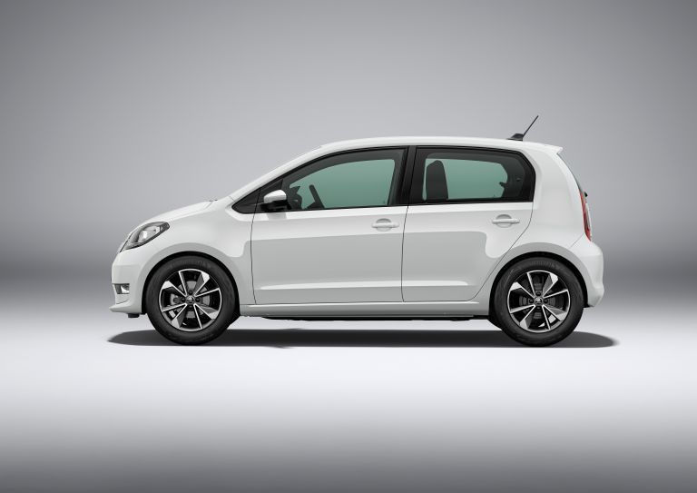 White Volkswagen Up parked on a grey studio background.