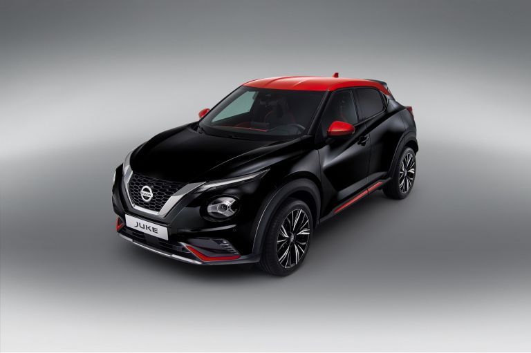 Black Nissan Juke with red accents on a grey studio background.