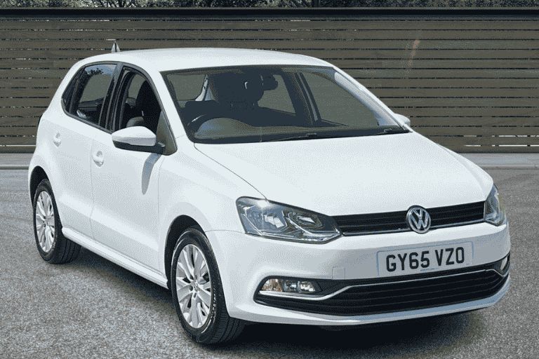 White Volkswagen Polo outside a car dealership