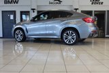 USED 2018 68 BMW X6 3.0 XDRIVE30D M SPORT 4d AUTO 255 BHP FINISHED IN STUNNING METALLIC GREY WITH ELECTRICALLY ADJUSTABLE FULL BLACK LEATHER HEATED SEATS WITH MEMORY PACK PLUS LUMBAR SUPPORT + 1 OWNER FROM NEW WITH A FULLY DOCUMENTED BMW MAIN DEALER SERVICE HISTORY AND THE BALANCE OF BMW'S MANUFACTURERS WARRANTY UNTIL OCTOBER 2021 + PROFESSIONAL SATELLITE NAVIGATION AND MEDIA + DRIVING ASSISTANT + DAB DIGITAL RADIO + BLUETOOTH MEDIA + HARMON KARDON SURROUND SOUND SYSTEM + HEATED FRONT AND REAR SEATS + HEAD UP DISPLAY + VOICE COMMAND + 360 VIEW CAMERA