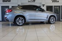 USED 2018 68 BMW X6 3.0 XDRIVE30D M SPORT 4d AUTO 255 BHP FINISHED IN STUNNING METALLIC GREY WITH ELECTRICALLY ADJUSTABLE FULL BLACK LEATHER HEATED SEATS WITH MEMORY PACK PLUS LUMBAR SUPPORT + 1 OWNER FROM NEW WITH A FULLY DOCUMENTED BMW MAIN DEALER SERVICE HISTORY AND THE BALANCE OF BMW'S MANUFACTURERS WARRANTY UNTIL OCTOBER 2021 + PROFESSIONAL SATELLITE NAVIGATION AND MEDIA + DRIVING ASSISTANT + DAB DIGITAL RADIO + BLUETOOTH MEDIA + HARMON KARDON SURROUND SOUND SYSTEM + HEATED FRONT AND REAR SEATS + HEAD UP DISPLAY + VOICE COMMAND + 360 VIEW CAMERA