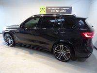 USED 2019 68 BMW X5 3.0 M50D 5d 395 BHP THIS INCREDIBLE SPORTS UTILITY VEHICLE COMES IN GLEAMING BLACK, IT IS THE EPITOME OF COMFORT, STYLE AND POWER, IT HAS AN AMAZING SET OF FEATURES INCLUDING 22" M ALLOY WHEELS, BMW DIGITAL PRO LIVE COCKPIT, SKY LOUNGE PANORAMIC SUNROOF, 3D PARKING CAMERA WITH PARK ASSIST, 12.3" SAT NAV, MEDIA INTERFACE SCREEN WITH BLUETOOTH AUDIO CONNECTION, 20GB HDD AND DAB RADIO, HARMON/KARDON SOUND SYSTEM, APPLE CAR PLAY, GESTURE CONTROL, HEATED LEATHER ELECTRIC ADJUST MEMORY SEATS, HEATED & COOLED CUP HOLDERS,