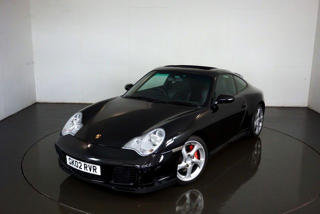 2002 02 Porsche 911 996 CARRERA 4S 3.6 TIPTRONIC 2d 316 BHP-Very Nice low mileage example finished in Basalt black metallic with Black leather upholstery-Only 2 Former keepers-Last Keeper since 2015-Supplied new by Lindbrook Porsche, Official Porsche Centre for Kent-13 Service Stamps in the Original Service book-7 OPC & 6 Specialist-3 Keys-Bose Sound-Climate control-Satnav-Electric Sunroof-Rear wiper-Rear parking Assistance-Cd changer-Litronic Headlights with Cleaning system-Sports Exhaust-Leather Roof Lining-Stainless Steel Entrance panels with model Typeface-The One to Have.