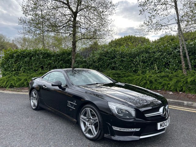 2012 12 Mercedes-Benz Sl 5.5 SL63 V8 AMG Convertible 2dr Petrol SpdS MCT Euro 5 (s/s) (537 ps)-Factory Extras Worth £7,695-Fantastic Low Mileage Example-Finished In Obsidian Black Metallic-Heated Ebony Leather Upholstery-Reverse Camera-Harman Kardon Sound-Airscarf-Glass Panoramic Vario Roof With Magic Sky Control With Switchable Transparency-19 Inch Alloy Wheels With Matching Pirelli Tyres-Dual Climate Control-Mfsw-Cruise Control-Dab Radio-Satnav-Bluetooth-11 Main Dealer Mercedes Services On File-This Car Has Clearly Led a Pampered Life. 