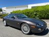 USED 2006 06 JAGUAR XKR 4.2 S Coupe 2dr Petrol Automatic (304 g/km, 400 bhp)-Rare Limited Edition XKR-S-Fantastic Low Mileage Example-2 Former Keepers-Last Keeper Since Aug 2011-Last Of The X100-White Badge-Finished In Copper Black Metallic-Heated Ivory Leather Upholstery-Recaro Sports Seats-Climate Control-20 Inch Split Rim Alloy Wheels-18 Services On File-Supplied New By Stratstone Jaguar Slough-Beautiful Example.The final run-out model was the S, which was available in four new colours in addition to the ones already on offer: Copper Black Metallic, Frost Blue Metallic, Bay Blue Metallic and Satin Silver Metallic. A revised white Jaguar Growler badge on the bonnet now featured chequered accents on either side. 