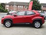 USED 2022 72 TOYOTA YARIS CROSS 1.5 VVT-h Icon SUV 5dr Petrol Hybrid E-CVT Euro 6 (s/s) (116 ps) Finished in SCARLET FLARE RED with Contrasting Dark Trim. This Yaris is a compact, self-charging hybrid SUV designed for all environments. It seamlessly blends electric and petrol power for efficiency, with no need to plug it in. Features include Low Mileage, Apple Play Nav, Rear View Camera, DAB Radio, Alloys, B/Tooth, Cruise Control and Balance of Toyota 5 Year Warranty (8 Years on EV Battery). Toyota Dealer serviced at 3421 miles and at 7010 miles.
