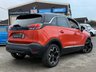USED 2022 22 VAUXHALL CROSSLAND 1.2 Turbo Ultimate SUV 5dr Petrol Manual Euro 6 (s/s) (130 ps) Finished in  POWER ORANGE MET with DARK GREY PART ALCANTARA TRIM. The Crossland is a spacious, practical, and economical family car. It represents a good-value, well-equipped family car that's easy to drive and cheap to run. Features include,  17" Alloy Wheels, Cruise Control, DAB Radio, Rear Camera, Parking Sensors, Black Roof, and much more. Dealer serviced at 5748 miles, 8789 miles and on arrival at 11589 miles.