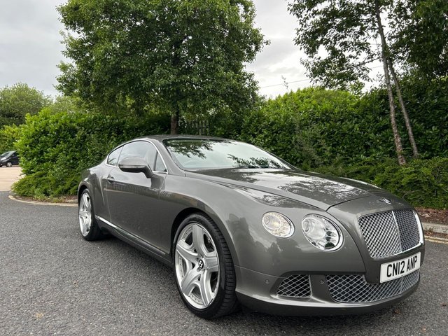 2012 12 Bentley 6 1/2 Litre 6.0 GT Coupe 2dr Auto 6 Speed 4WD Euro 5 (575 ps)-Fantastic Low Mileage Example,Finished In Granite Metallic With Linen Hide-Mulliner Driving Specification-Contrast Stitching-Mfsw-Dual Climate Control-Cruise Control-Satnav-Bluetooth-Burr Walnut Interior Trim-Keyless Entry-Veneer Door & Rear Quater Inserts-Cd Changer-Rear View Camera- 21 Inch 5 Spoke Two Piece Alloy Wheels-Great Colour Combination.