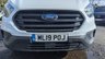 USED 2019 19 FORD TRANSIT CUSTOM L2 H2 LEADER 340 TDCI 130 PS LWB High Roof With Air Conditioning, Electric Windows, Racked Ready for work, Parking Sensors, Security Locks, Bulkhead in great condition . 1 Owner from New - 2 Keys - 6 Service Stamps in the book (Last Serviced @ 90,567 miles) . Presenting a superb example of a hard-working and well-maintained light commercial vehicle, this Ford Custom L2 H2 Leader 340 TDCI is ready to roll. Finished in a clean and professional white, this L2 H2 high roof variant offers the ideal combination of spacious cargo volume and urban-friendly dimensions.  Under the bonnet sits the reliable and punchy 130 PS Duratorq diesel engine, providing ample power for motorway miles and fully laden loads. This is a one-owner-from-new vehicle, which speaks volumes about its careful history. It comes complete with both original keys and a comprehensive service book stamped six times, with the most recent service completed at 90,567 miles, ensuring it is ready for the next chapter of its working life.  Step inside to find a practical and comfortable cabin equipped with air conditioning for year-round comfort and electric front windows for convenience. The interior also features a heavy-duty bulkhead, providing crucial protection for the driver and separation from the load area.  The van is immediately work-ready, with the cargo bay already professionally racked out to keep tools and equipment organised and secure. Manoeuvring and parking in tight spots is made significantly easier thanks to the inclusion of rear parking sensors. Added security is provided by fitted security locks, offering peace of mind when the van is left unattended.  This Ford Custom is presented in great condition throughout, reflecting its single-owner history and regular maintenance. It represents a fantastic opportunity for any tradesperson or business looking for a dependable, well-specced, and ready-to-go workhorse. 