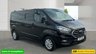 USED 2021 71 FORD TRANSIT CUSTOM Black 2.0 300 EcoBlue Limited L2 van, 26,700 miles, Rear seats & windows Conversion, Euro 6, 6-Speed manual, A/C, alloys, F&R sensors. Plus VAT @ 20%! This 2021 Ford Transit Custom 300 Limited has been maintained by only one owner and has covered just 26,700 miles. This 2.0 litre diesel van is a Limited trim model, featuring the Euro 6 emission standard and an MOT valid until October 2026. Inside, the cabin is equipped with front manual air conditioning and the ICE Feature Pack 21, which includes Bluetooth connectivity for your devices. The vehicle also comes with the Visibility Pack High, providing automatic headlights with a follow me home f