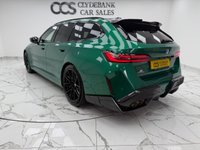 USED 2025 25 BMW M5 4.4 22.1kWh Touring 5dr Petrol Plug-in Hybrid Steptronic xDrive Euro 6 (s/s) (727 ps) Finished In Metalic Isle Of Man Green, This M5 Comes With The Driving Assistant Pro Package, Glass Panoramic Roof, Comfort Package, 20 & 21" M Light Alloy Wheels,  With Sport Tyres, Anthracite Alacantra Headlining, Towbar, M Carbon Side Mirror Caps, Adaptive LED Headlights, BMW Iconic Glow Exterior Pack, M Multifunction Seat, M Multifunction Seat, Front And Rear Heated Seats,CT Front Splitter Carbon Rear Diffuser, Parking Assistance System Plus, Bowers And Wilkins Surround Sound System.